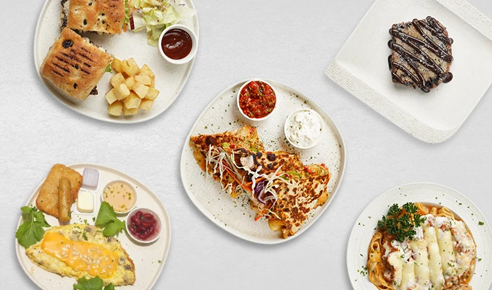 A spread of Mondo dishes: a breakfast plate, grilled focaccia with potatoes, a quesadilla with salsa, pasta and a chocolate brownie
